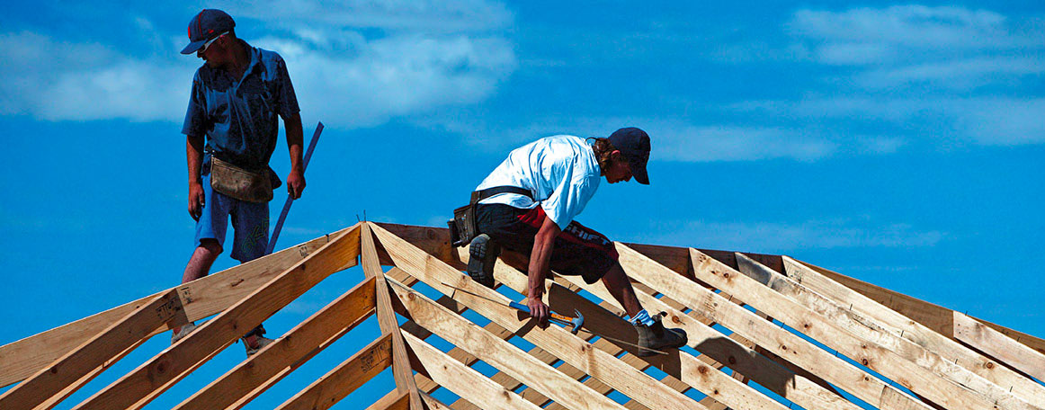 Builders on a rooftop - building afforable housing