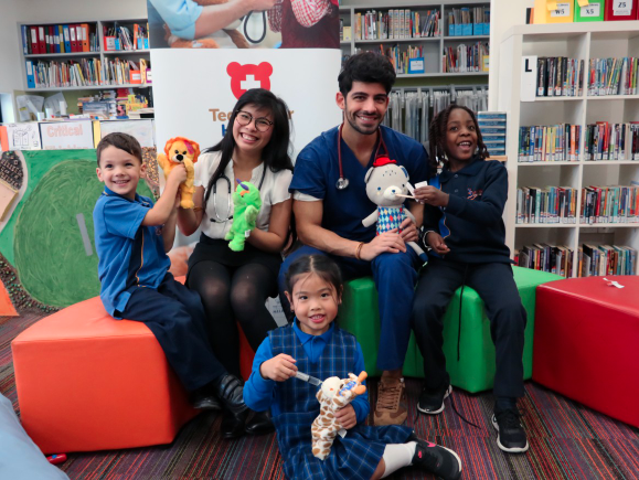 Image of students of the medical faculty running the Teddy Bear Hospital pictured with children at Derrimut Primary School.