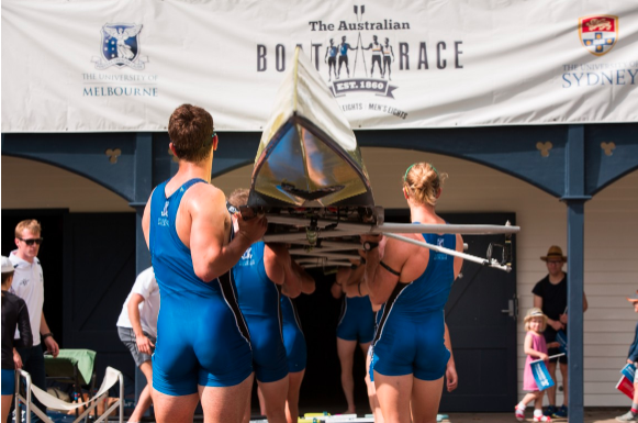 Image of the University of Melbourne rowing crew carrying a boat.