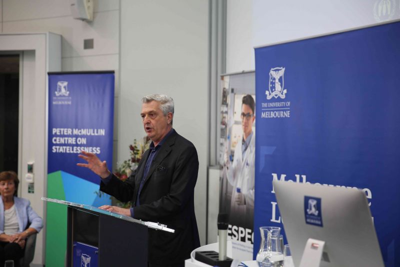 A man stands at a podium giving a lecture