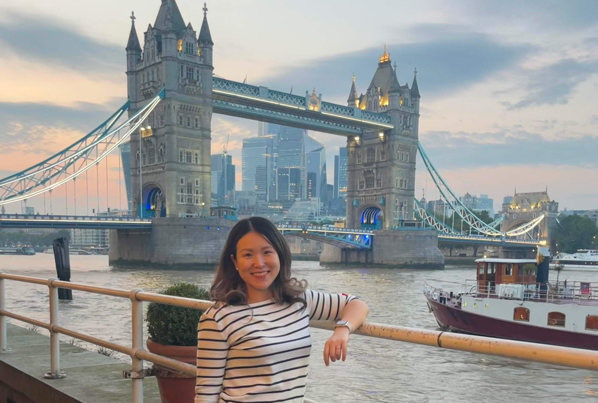 Kinsey Li standing in front of Tower Bridge in London.