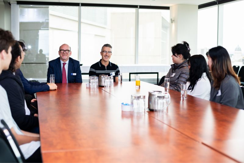 Chris Crellin and Deputy Dean, Faculty Business and Economics Professor Paul Jensen with talking with University students at a Fireside Chat in October 2024.