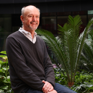 A portrait shot of a mentor smiling into the distance.
                                class=
