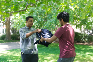 Undergraduate student Shashwata Majumder presented Osamah with a University of Melbourne hoodie welcome gift.