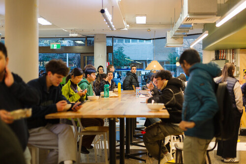 A group of friends enjoying a meal together at a table.