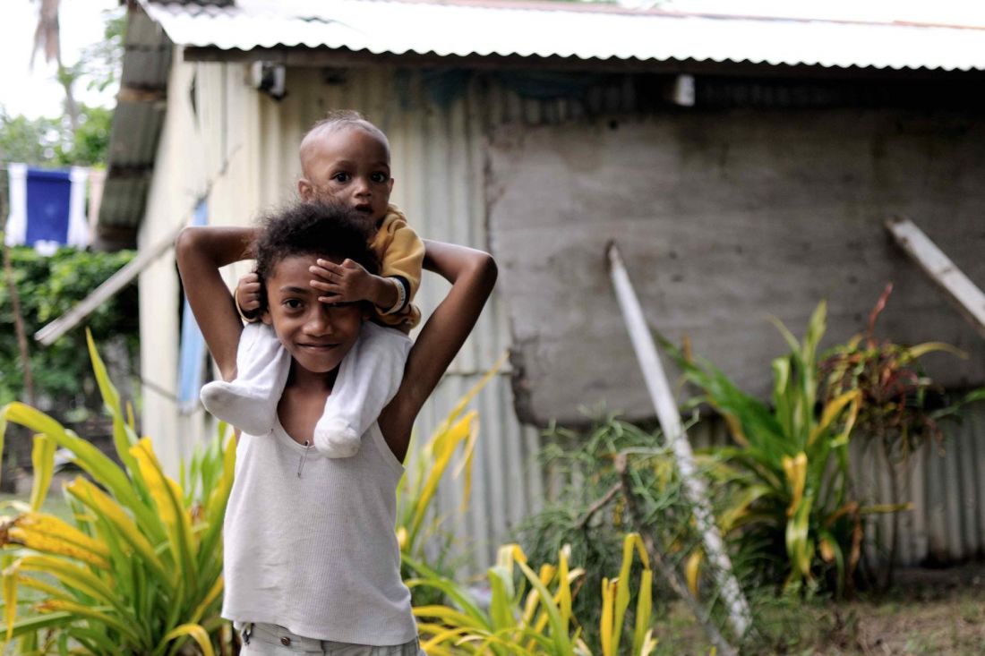 Baby on boy's shoulders 