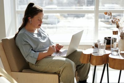 Image of a person living with disability working on a computer.