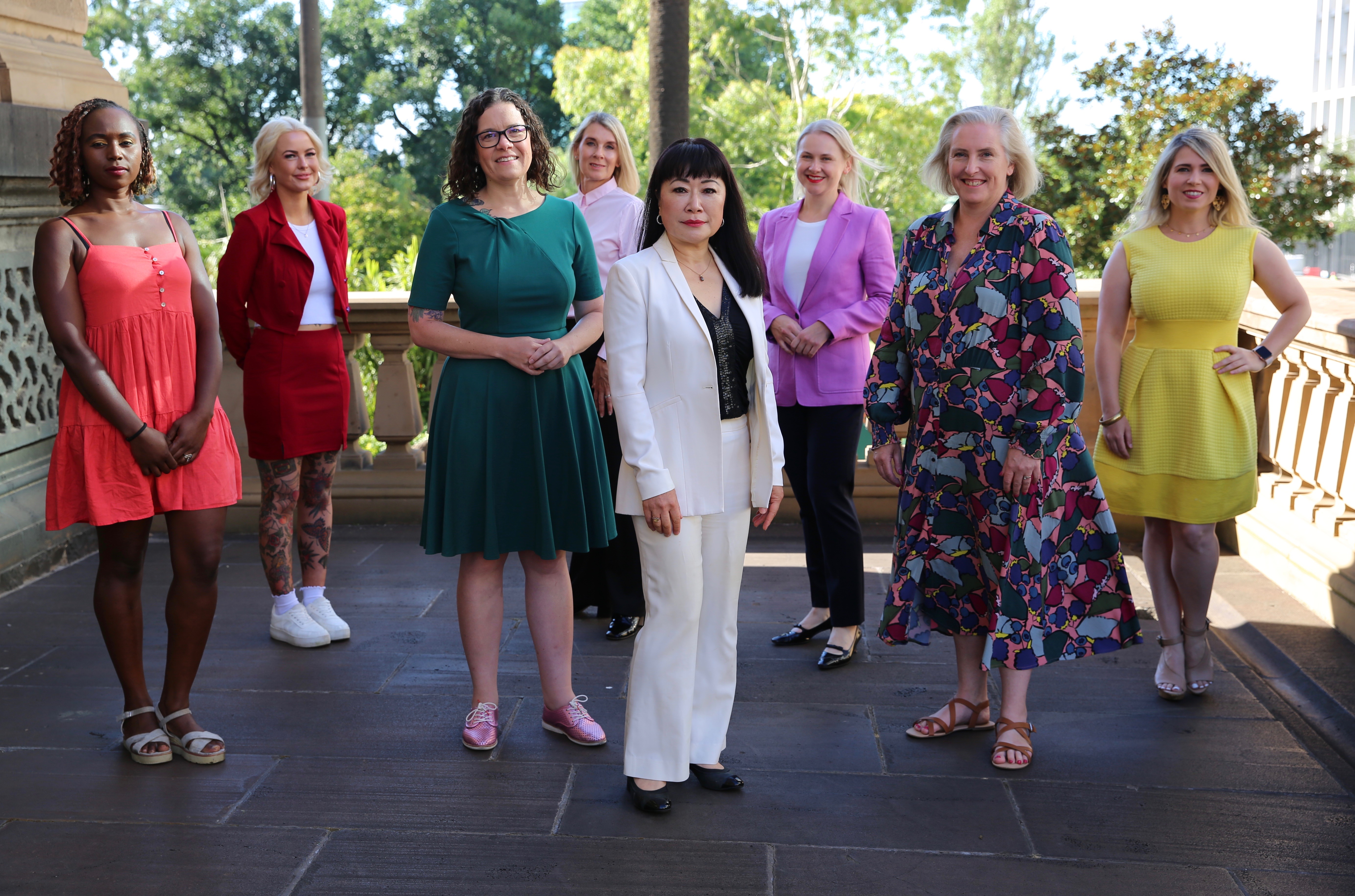 Group of diverse women wearing brightly coloured clothes in an historical setting