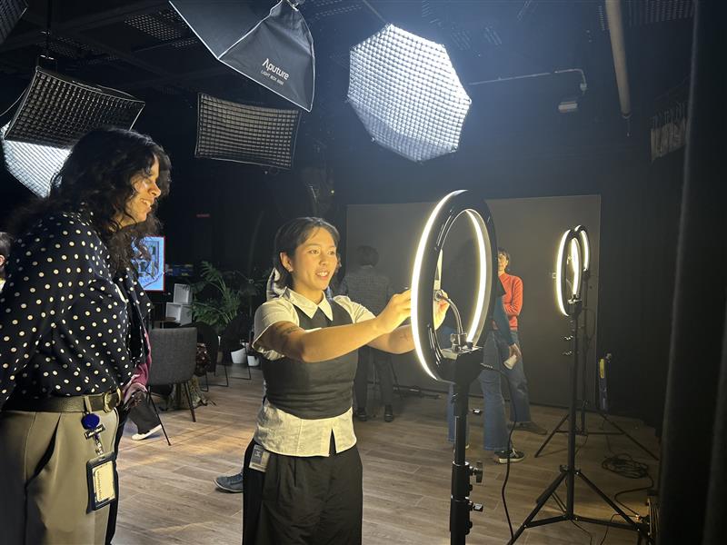 Two DIY media makers in a studio playing around with ring lights