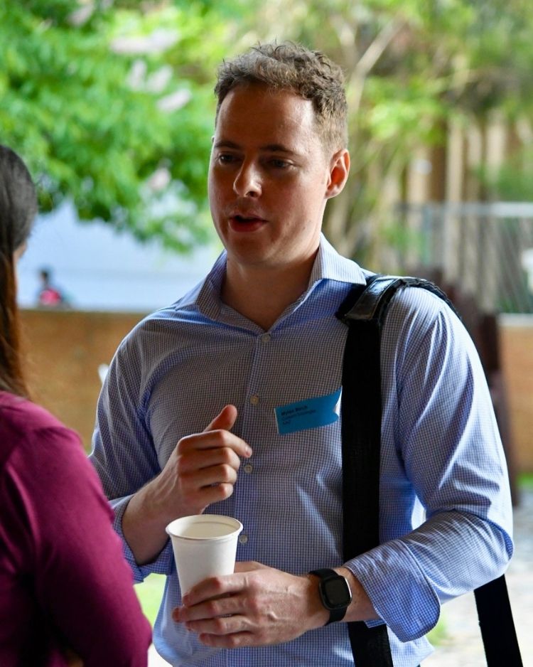 Alum Myles Birch talking to a student