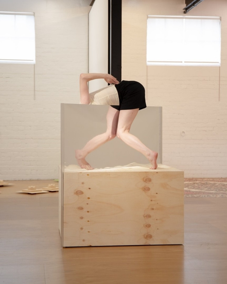 A leg reflected in a mirror on a box