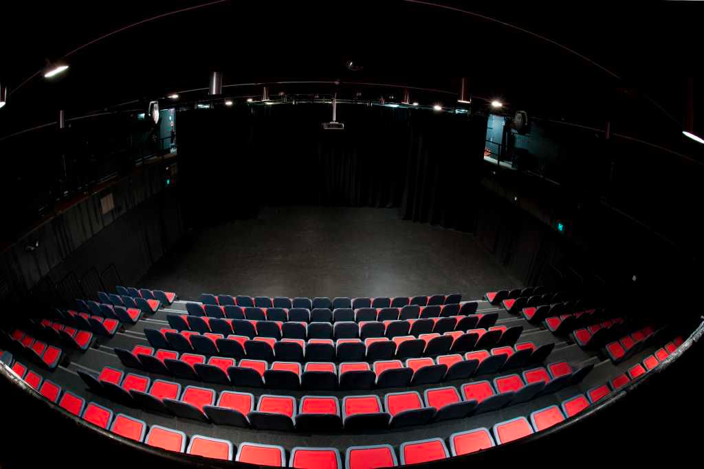Empty lecture theatre with red seats