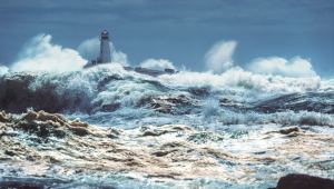 Storm waves in the ocean and lighthouse 