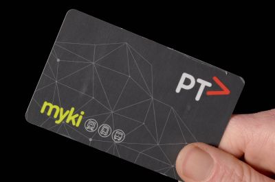 A hand holding a Myki transport card