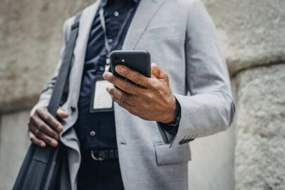 Image of a man holding a mobile phone.