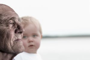 Close up of grandfather's face, young boy in the background