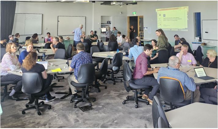 A classroom of staff sitting at tables