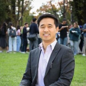 An alumni mentor smiling to camera at University Square.
                                class=