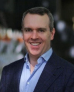 A headshot of Merric Foley.
