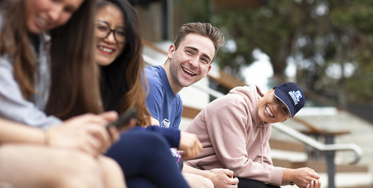 Group of students chatting and enjoying the outdoors.