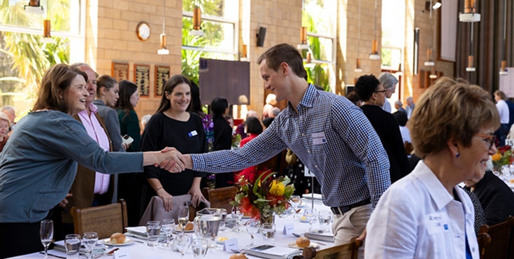 Several alumni meet and greet at a Heritage Society luncheon.