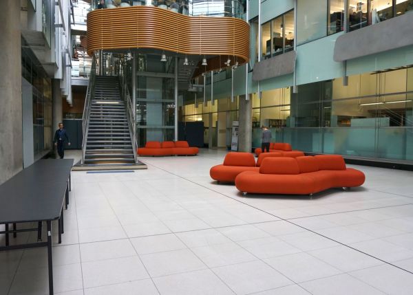 Bio21 Atrium with large orange lounges in centre.