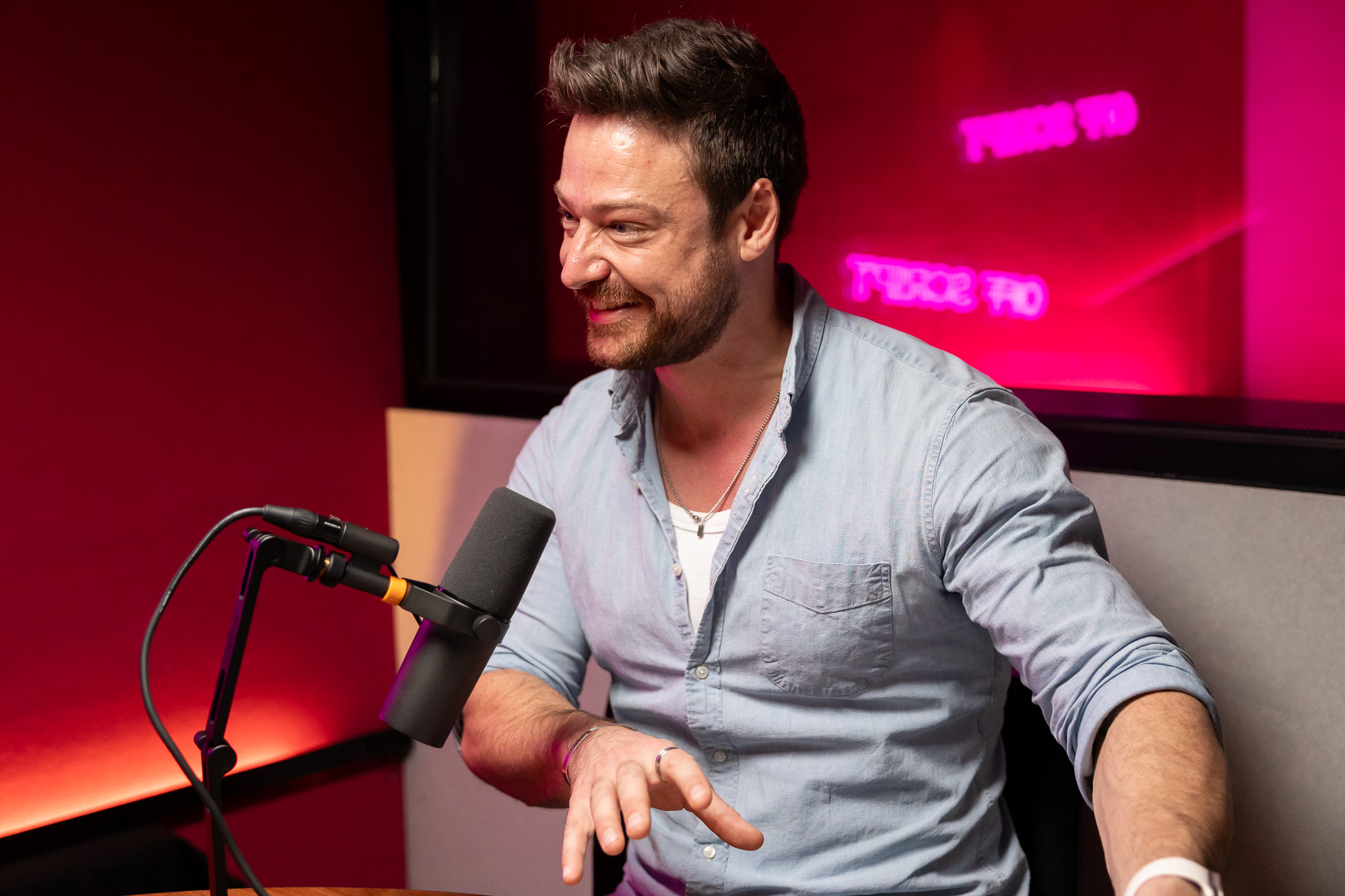 Man smiling in podcast studio