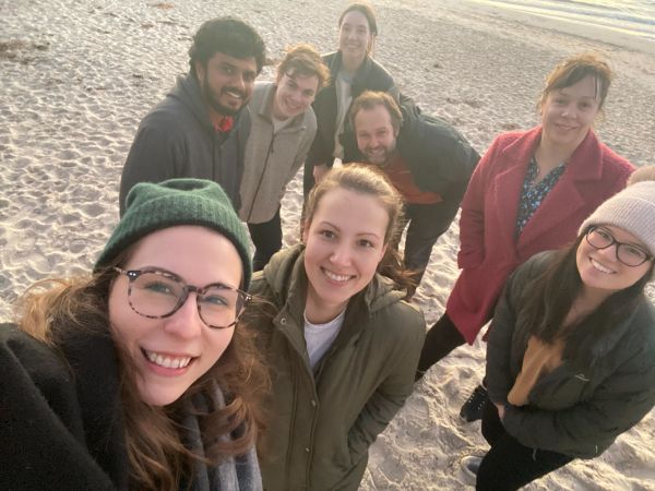 A group of people taking a selfie at the beach