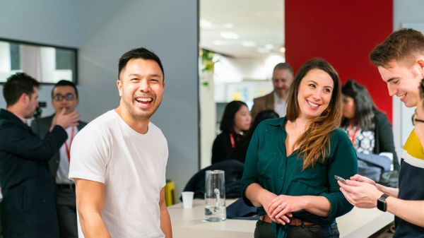 Smiling participants socialising in casual setting
