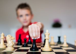Child moving chess piece