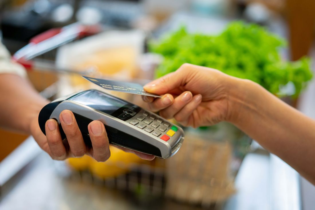 Someone paying via EFTPOS machine 
