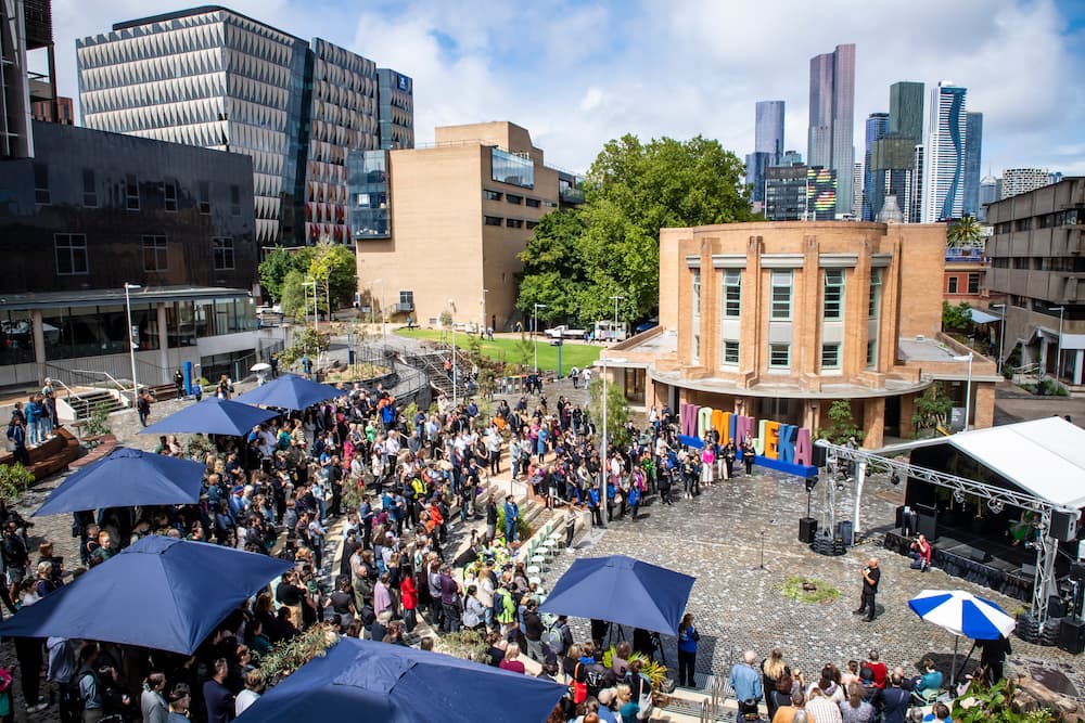 A wide-angle shot of a crowd of people gather for Wominjeka 2023