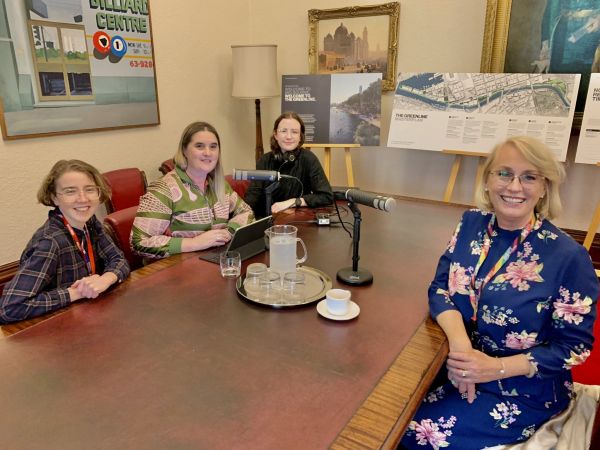 Four people sitting around a table posing for a photo