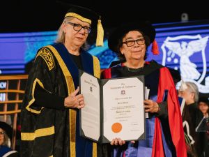 Professor Su Baker (left) presents Dr Alexis Wright with her Honorary Doctorate. Image credit: Silver Rose Graduations