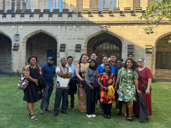 A group of around 15 Australia Awards fellows on the grass of the Old Quad