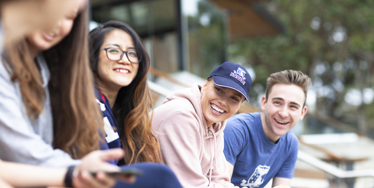 A group of students laughing and talking.