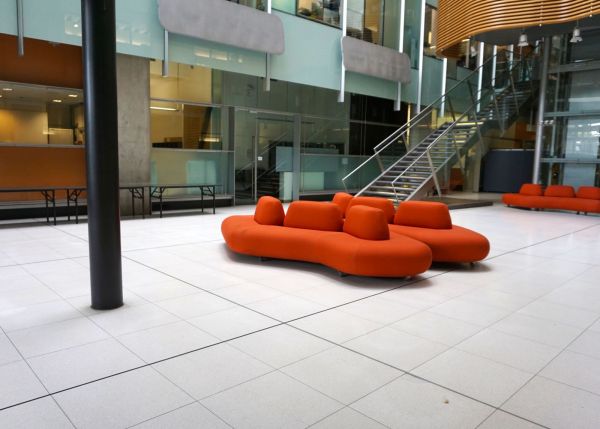 Bio21 Atrium with large orange lounges in centre.