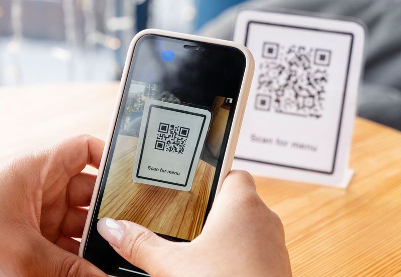 A photo of someone scanning a QR code
