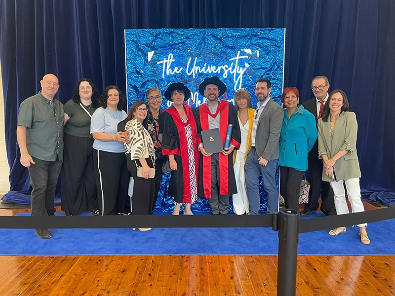 Miguel at his PhD graduation event with Professor Wells and his family.