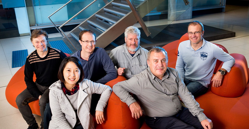 A group of people sitting on red couches