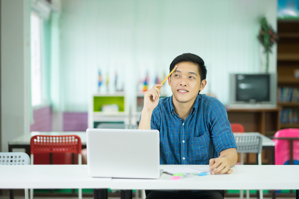 Student at laptop thinking