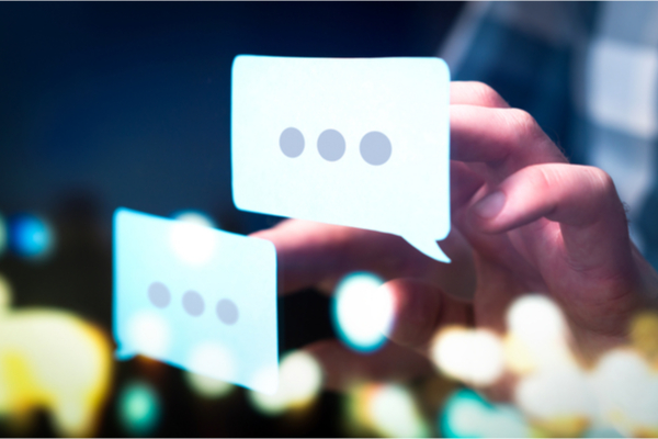 Two speech bubbles with hand selecting one