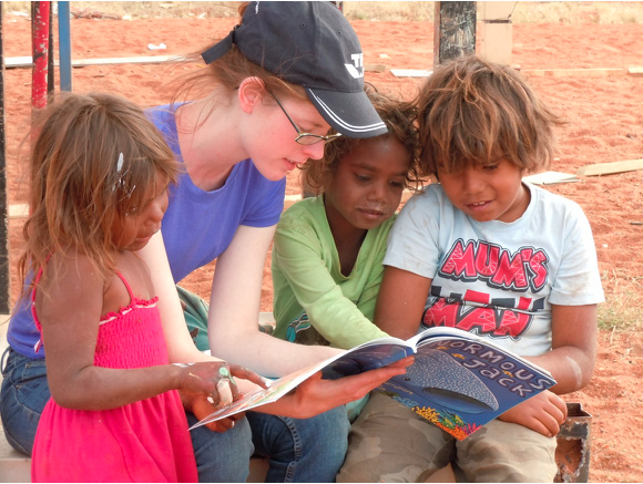 Image of teacher with children.