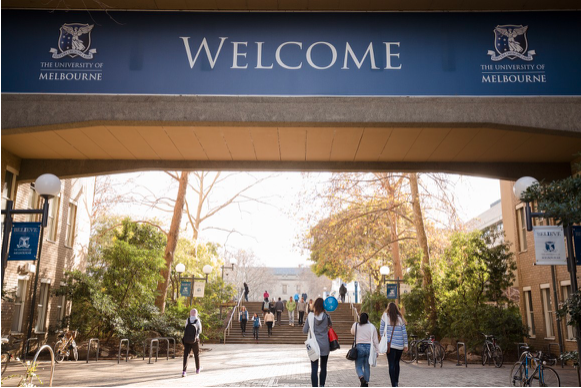 Image of the entrance to the University of Melbourne with a 'Welcome' banner.
