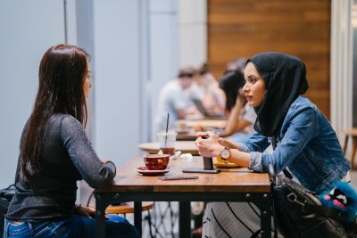 Two women sitting at a coffee shop 