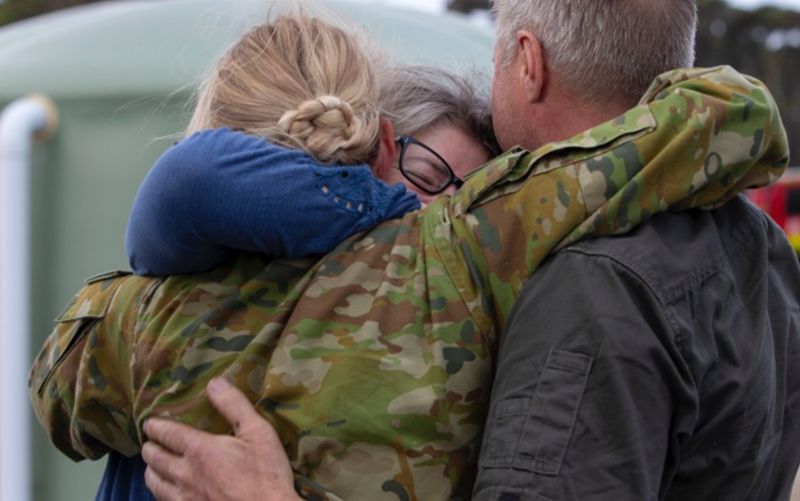 Stock image of military personnel embracing loved ones.