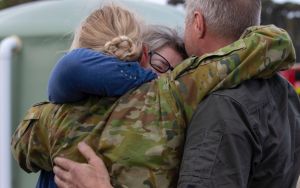 Stock image of military personnel embracing loved ones.