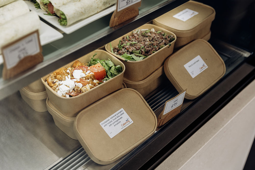 Brown cardboard meal containers in a display case