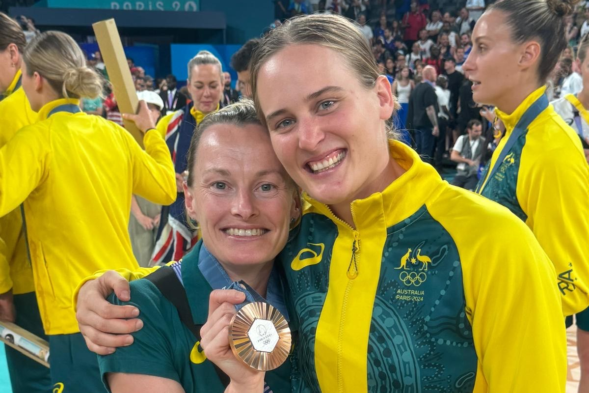 Alice McNamara with Opals Guard Kristy Wallace after winning bronze at the 2024 Paris Olympics.