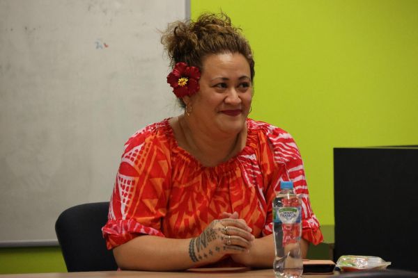 A Samoan academic seated at a table, in discussion